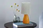Milkshake bedside table lamp with warm LED light on a nightstand in a cozy bedroom