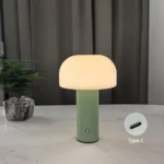 Modern mushroom table lamp with warm glow on wooden table