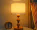 Vintage table lamp with fabric shade and solid wood base on bedside table