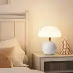 Mushroom table lamp with cream ceramic shade on bedside table