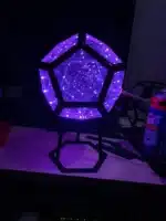 Dodecahedron gaming light with vibrant RGBW colors illuminating a gaming desk setup