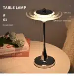 Goldoma rechargeable table lamp with flying saucer shape and warm glow on a bedside table