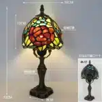 Tiffany table lamp with colorful stained glass shade casting warm glow on nightstand