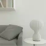 Wabi sabi floor lamp with textured fabric shade in a cozy living room corner