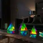 3D pyramid night light with RGB color modes on a bedside table