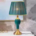 Green ceramic table lamp with European cloth shade in a modern living room setting