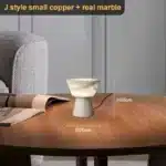 Elegant marble table lamp with soft glow on bedside table in bedroom