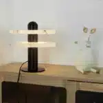 Elegant marble table lamp with soft glow on bedside table in bedroom