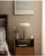 White glass table lamp with vintage design on a wooden desk in a cozy bedroom