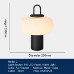 Modern table lamp with glass shade on bedside table
