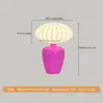 Vintage table lamp with retro ceramic base and silk shade on bedside table in cozy bedroom