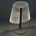 3D LED table lamp with wooden base and acrylic art glowing in a cozy room
