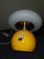 Mushroom table lamp with cream ceramic shade on bedside table