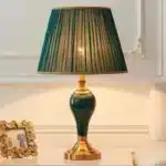 Green ceramic table lamp with European cloth shade in a modern living room setting