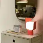 Rotating petal desk lamp with adjustable petals in pastel colors on a bedside table