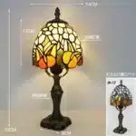 Tiffany table lamp with colorful stained glass shade casting warm glow on nightstand