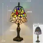 Tiffany table lamp with colorful stained glass shade casting warm glow on nightstand