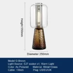 Modern table lamp with glass shade on bedside table