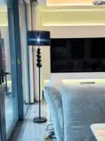 Modern crystal floor lamp with black finish and LED light in a living room