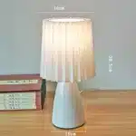 Milkshake bedside table lamp with warm LED light on a nightstand in a cozy bedroom