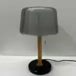 Modern bedside lamp with cream glass shade on a nightstand