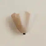 Modern wall sconce with shell-shaped glass and LED light in a minimalist living room