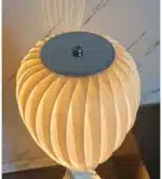 Wooden floor lamp with warm glow in a cozy living room