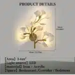Luxury gold leaf sconce with modern ginkgo design illuminating a living room wall