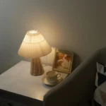 Handmade rattan bedside lamp with pleated shade on vintage nightstand