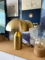 Modern mushroom table lamp with metal shade and wood base on bedside table
