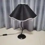 Elegant handmade petal lampshade casting a warm glow in a cozy bedroom