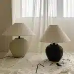 Wabi sabi table lamp with textured ceramic base and linen shade in a cozy living room