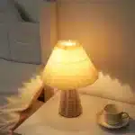 Handmade rattan bedside lamp with pleated shade on vintage nightstand