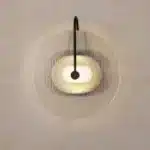 Modern wall lamp with minimalist Nordic design illuminating a cozy bedroom bedside