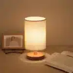Modern linen table lamp with USB port and touch control on bedside table