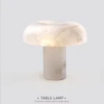Elegant marble table lamp with soft glow on bedside table in bedroom