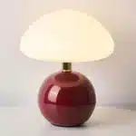 Mushroom table lamp with cream ceramic shade on bedside table