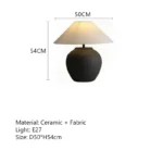 Wabi sabi table lamp with textured ceramic base and linen shade in a cozy living room