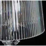 Modern acrylic table lamp glowing softly on a bedside table in a contemporary bedroom