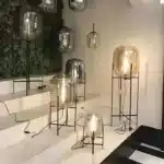 Modern floor lamp with iron frame and glass shade in a cozy living room