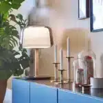 Modern bedside lamp with cream glass shade on a nightstand