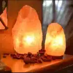 Salt lamp with color changing on wooden base glowing in warm light