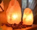 Salt lamp with color changing on wooden base glowing in warm light