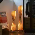 Wooden floor lamp with warm glow in a cozy living room