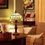 Vintage table lamp with handmade colored glass shade casting warm ambient light