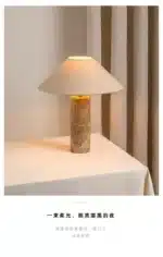 Modern marble LED table lamp with white fabric shade on wooden desk