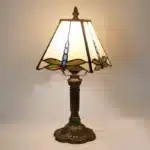 Vintage table lamp with handmade colored glass shade casting warm ambient light