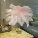 Ostrich feather table lamp glowing warmly on a bedside table in a cozy bedroom