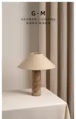 Modern marble LED table lamp with white fabric shade on wooden desk