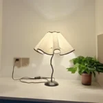 Elegant handmade petal lampshade casting a warm glow in a cozy bedroom